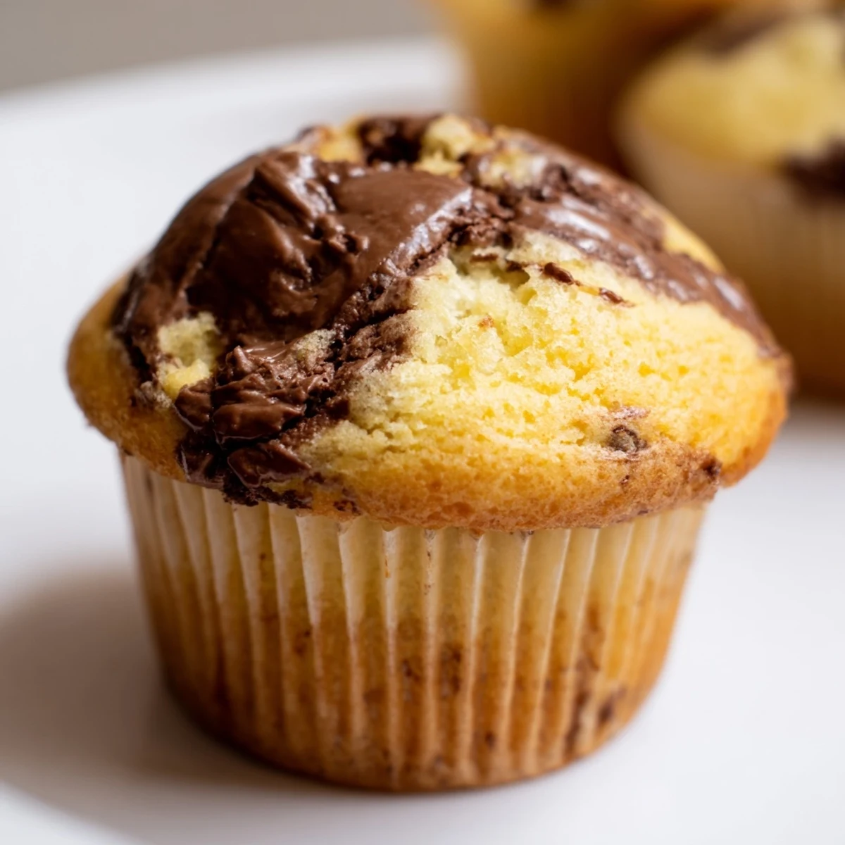 Warm Nutella swirled muffins topped with ripe banana chunks ready for morning snacking