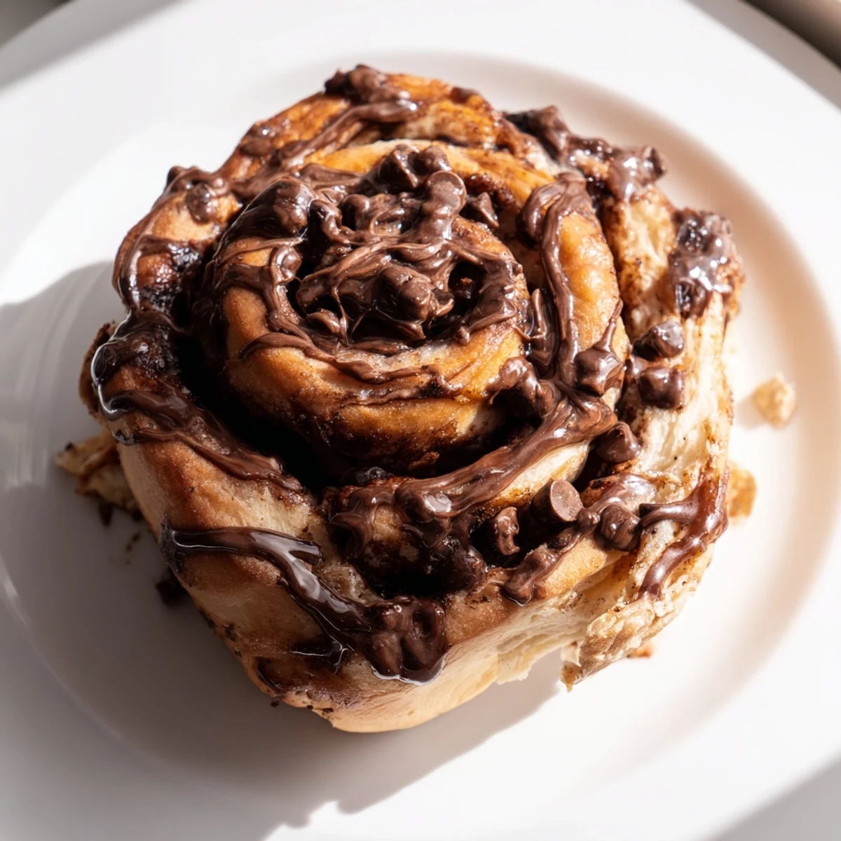 Freshly baked double chocolate cinnamon rolls with rich chocolate glaze drizzling down the sides