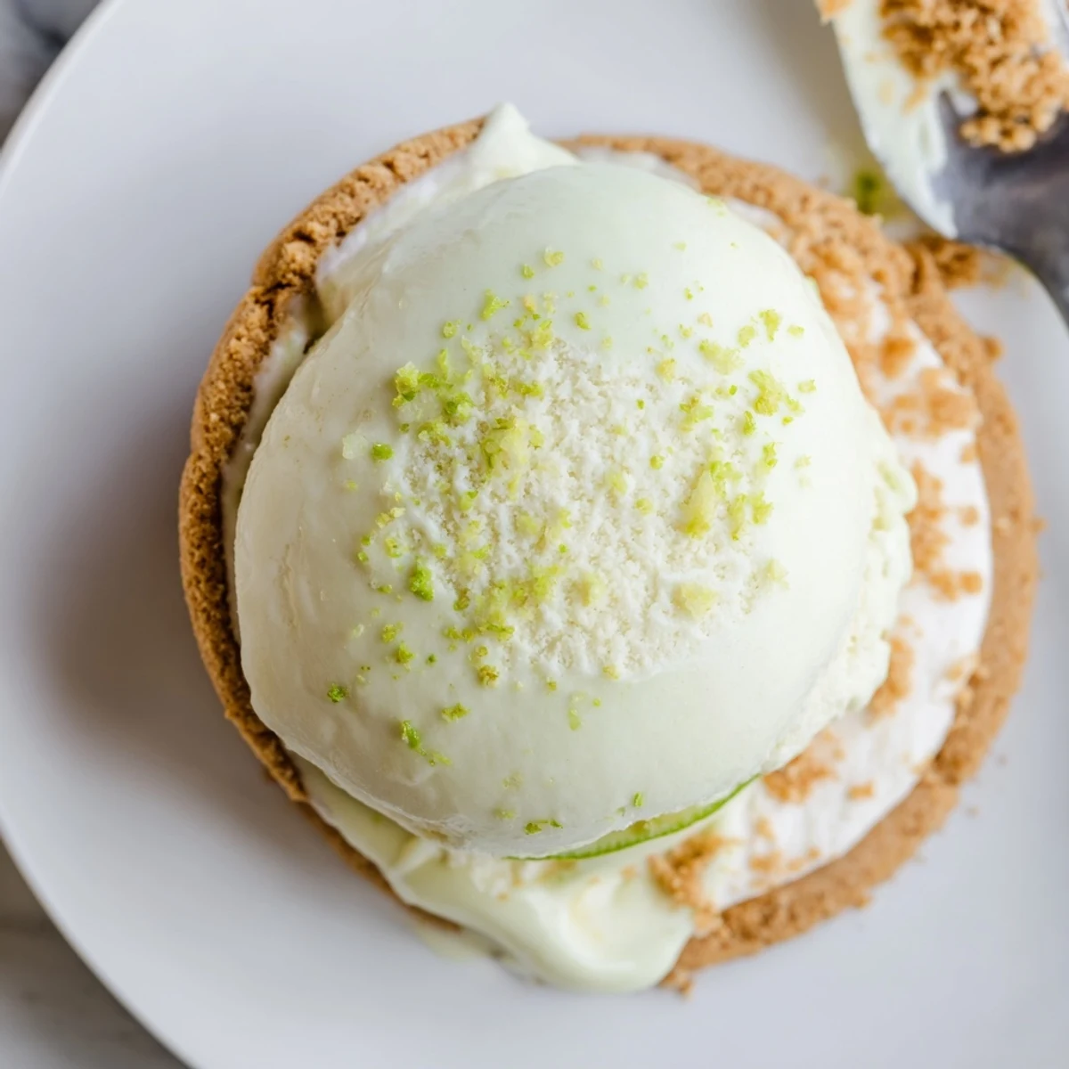 Chilled Key Lime Pie Ice Cream Sandwiches stacked on chilled plate, creamy tart contrast