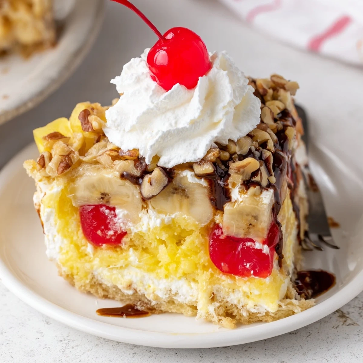 Bubbling Banana Split Dump Cake in baking dish, golden crust topped with cherries