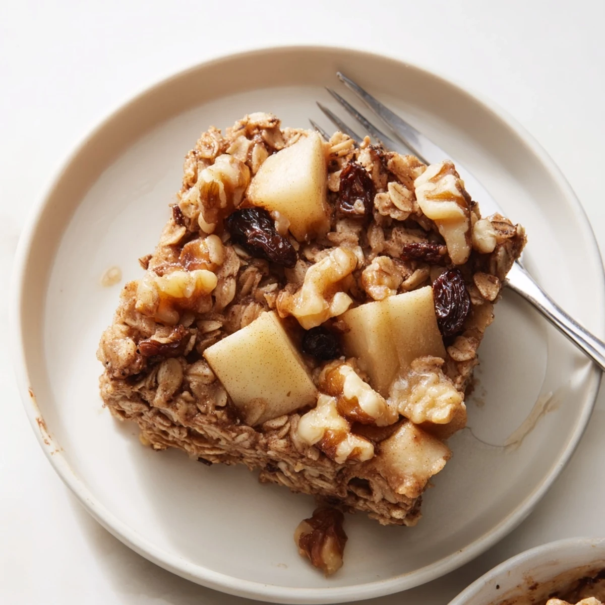 Bubbly, apple-studded Delicious Apple Cinnamon Oatmeal Bake Recipe For Mornings drizzled with maple