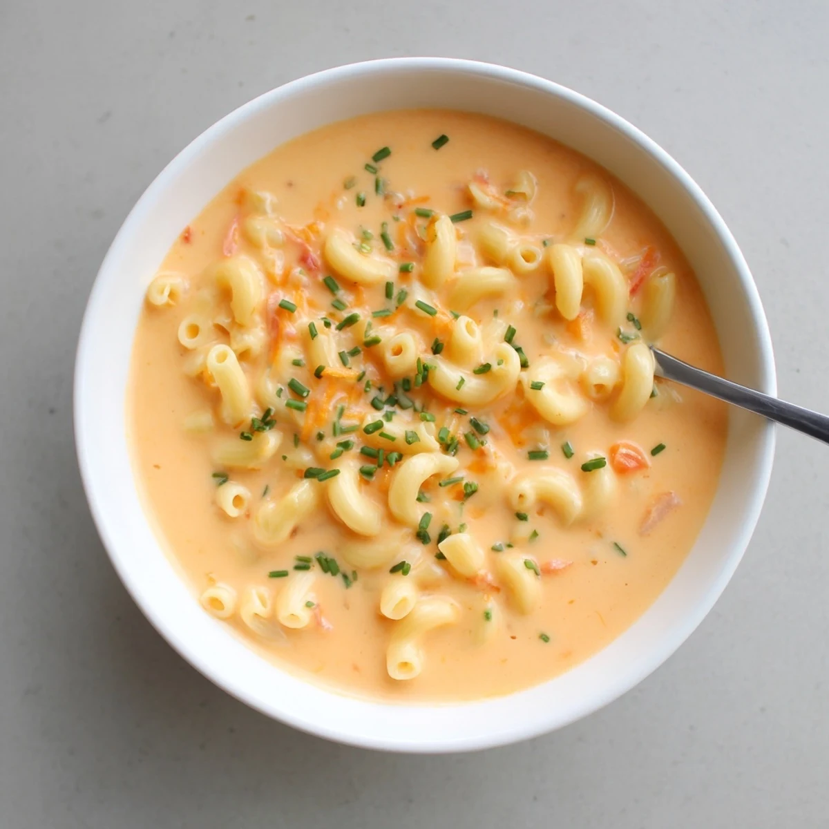 Golden macaroni swimming in rich melted cheddar cheese broth served piping hot with crusty bread on the side