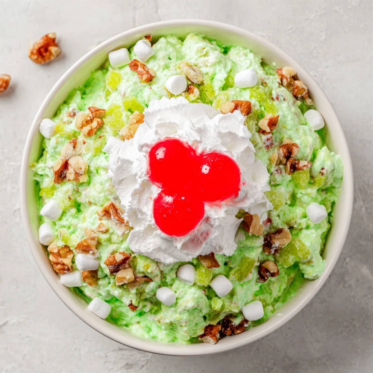 Creamy Watergate Salad recipe displaying bright green pistachio pudding mixed with crushed pineapple and fluffy whipped topping