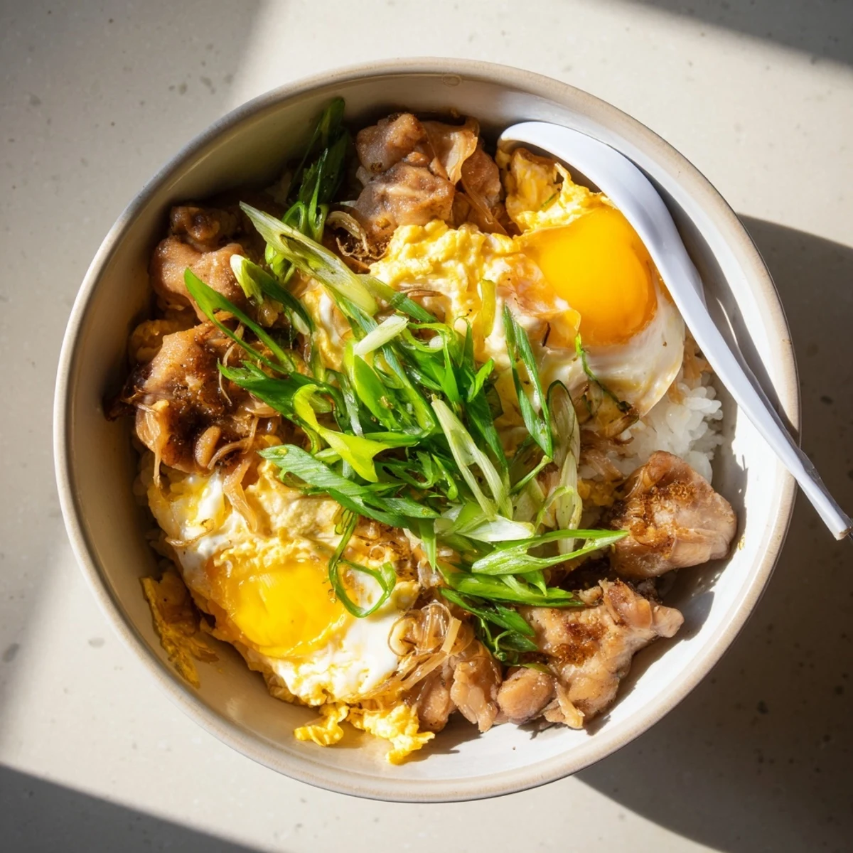 Comforting Japanese one pot Oyakodon with juicy chicken thighs and creamy eggs in sweet caramelized sauce