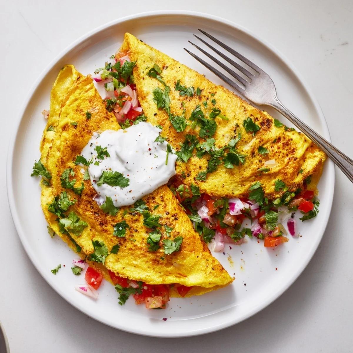 Golden healthy Afghani omelette with fresh tomatoes, peppers, and aromatic herbs