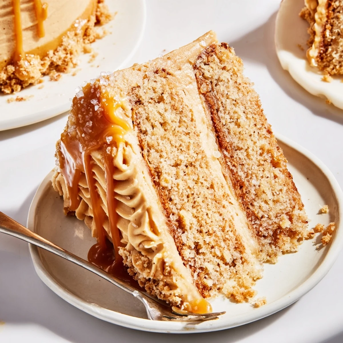 Slice of salted caramel brown butter banana cake showcasing tender crumb and luscious caramel topping