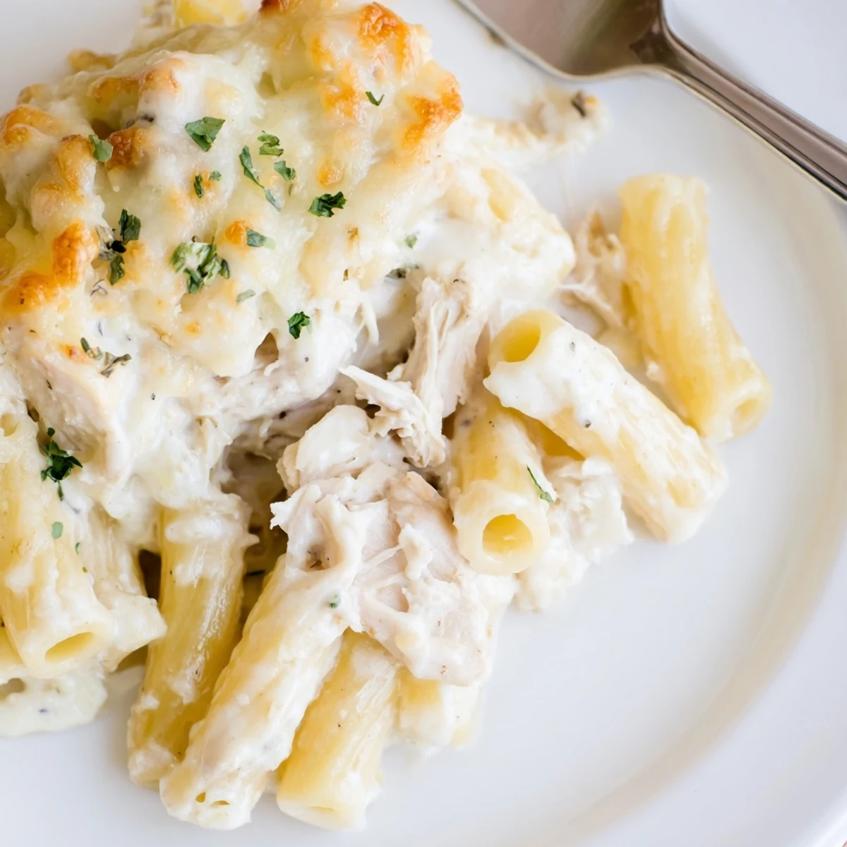 Bubbly golden top of Creamy Chicken Alfredo Bake With Mozzarella Crust