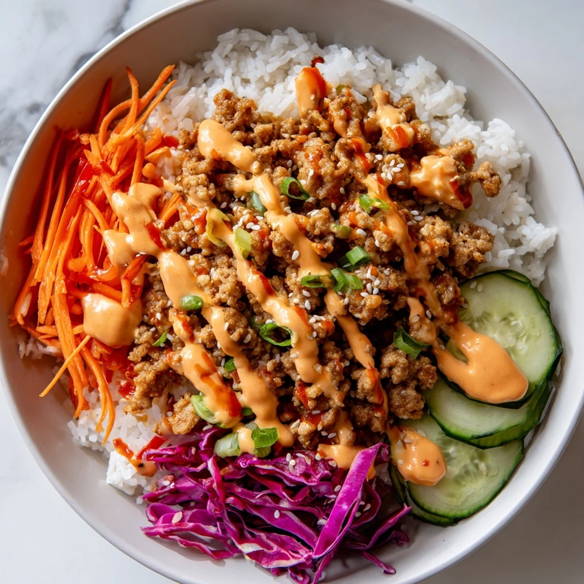 Ground Turkey Rice Bowls drizzled with creamy spicy Bang Bang Sauce and crisp vegetables